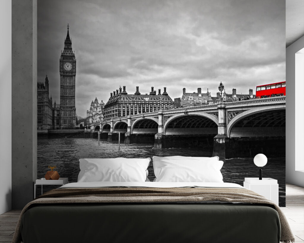 Bridge over water with a clock tower and a red bus