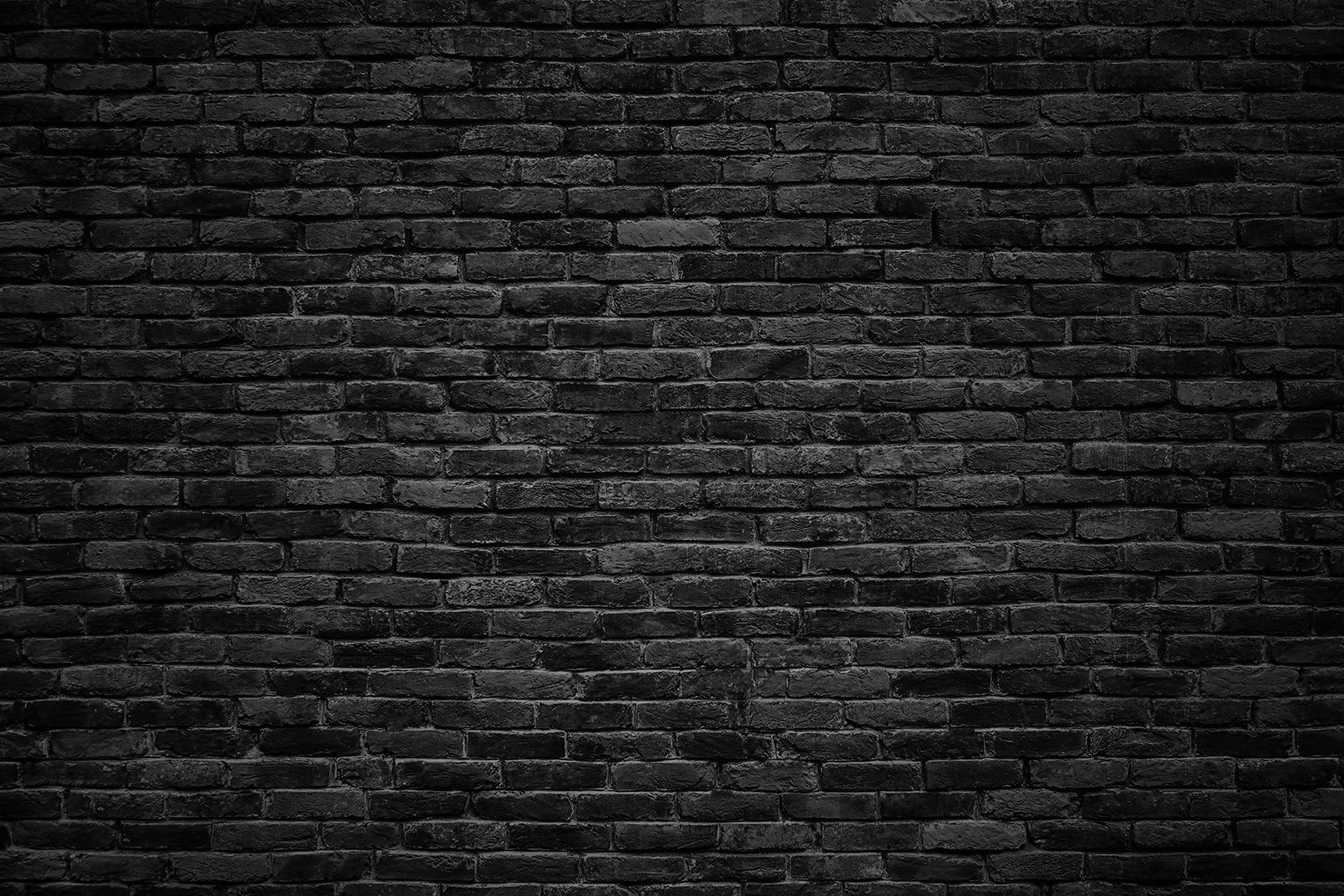 Black brick wall with a white spot Black brick wall with a white spot