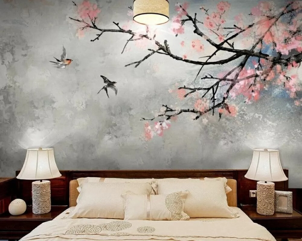 Tree branch with pink flowers and birds flying
