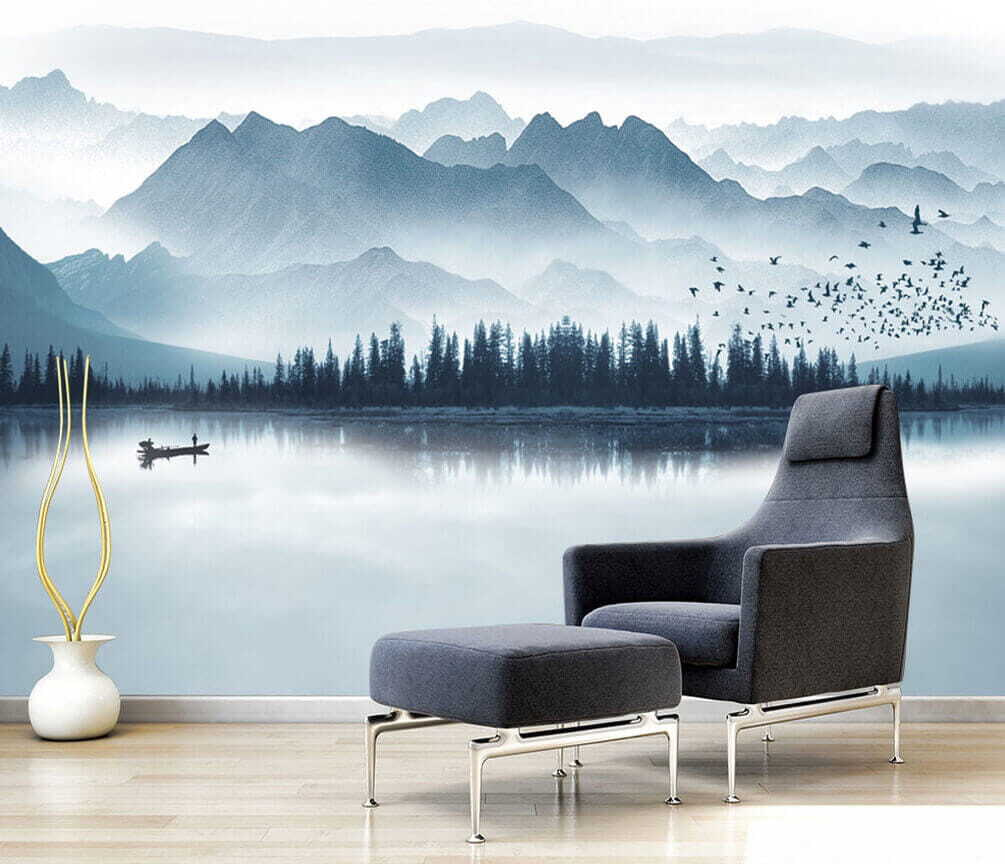 Person in a boat on a lake with mountains in the background