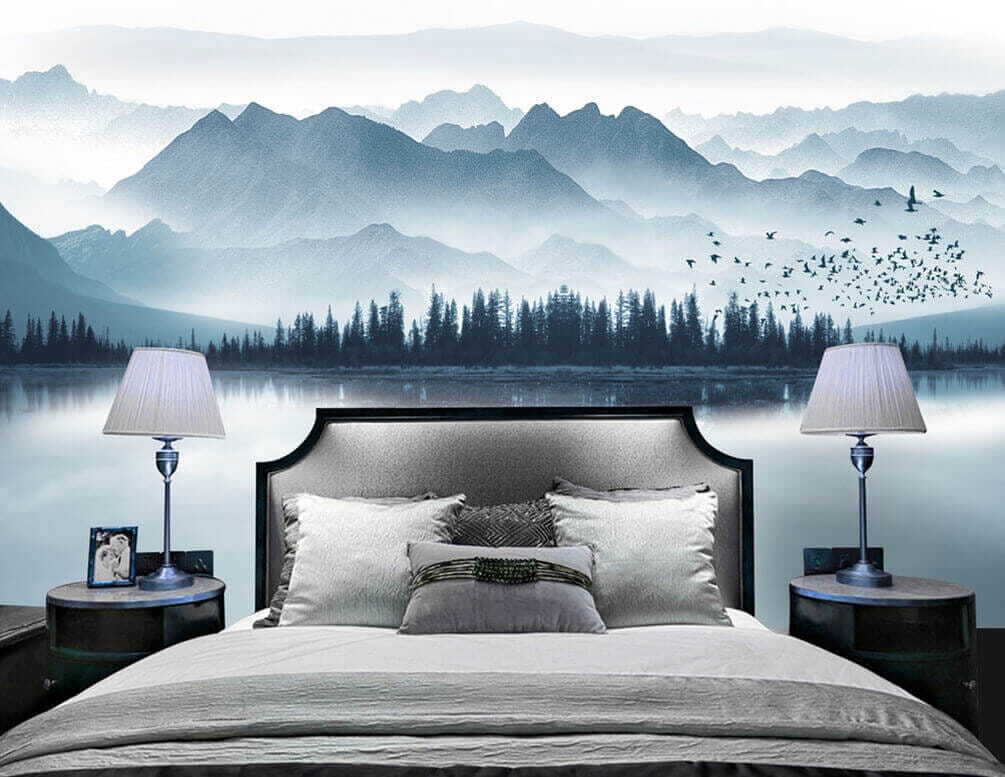 Person in a boat on a lake with mountains in the background