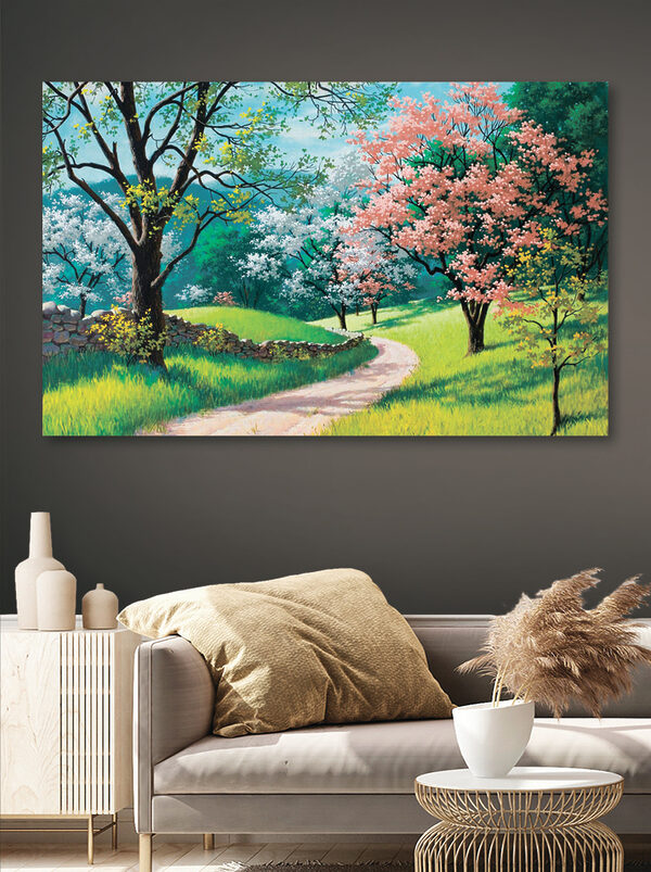 A dirt road through a grassy field with trees and a stone wall A dirt road through a grassy field with trees and a stone wall