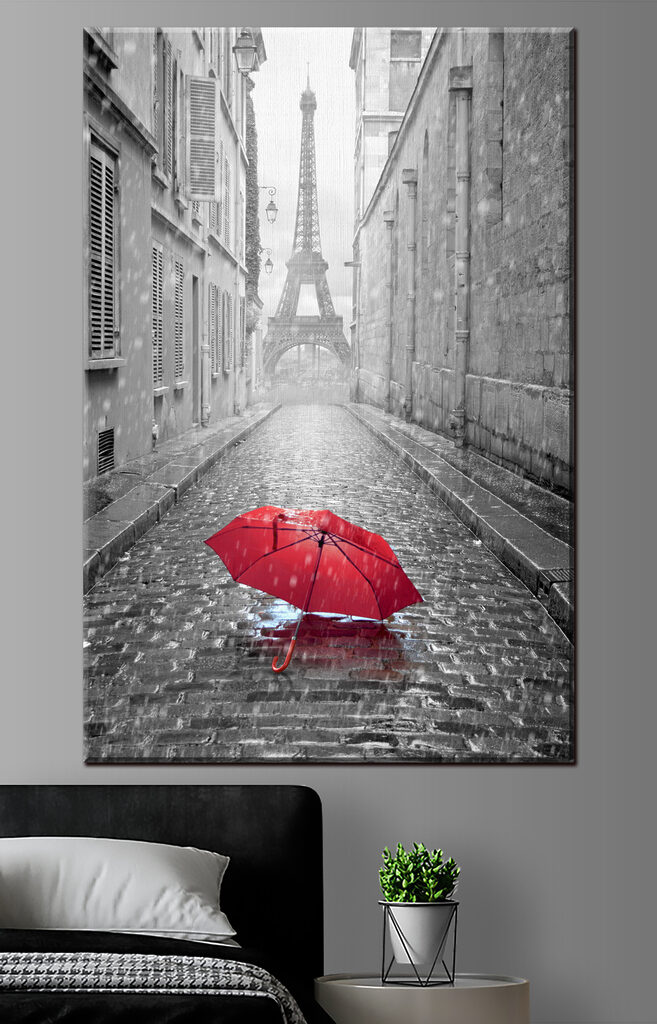 A red umbrella in a street with a tower in the background