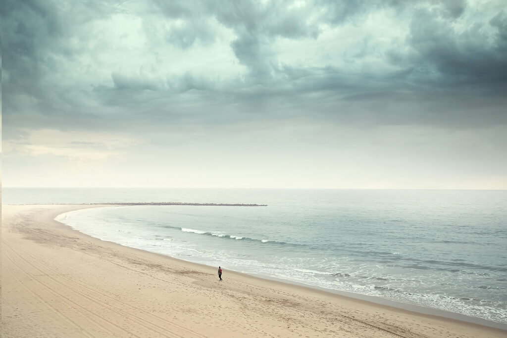 A person walking on a beach