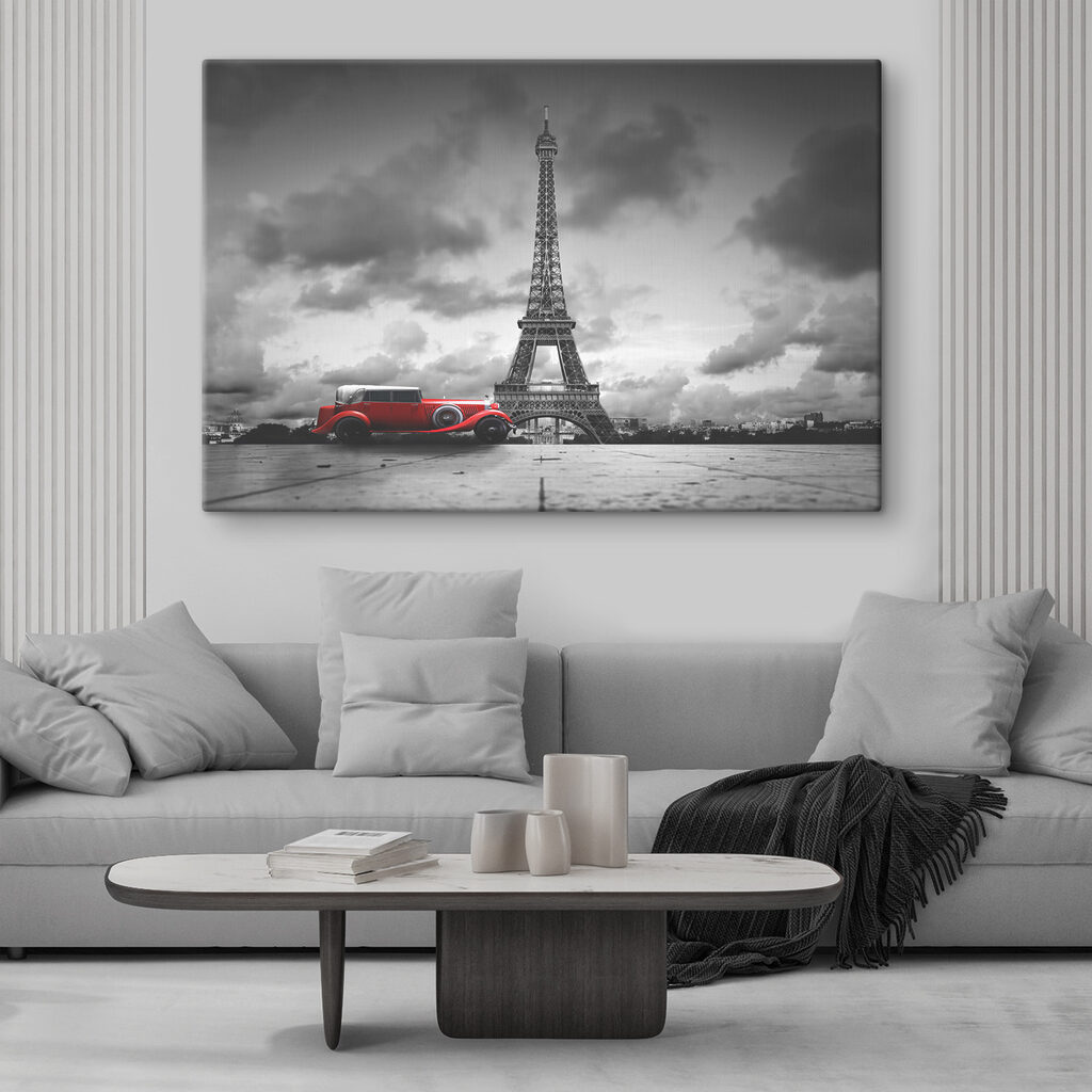 A red car parked in front of a large tower A red car parked in front of a large tower