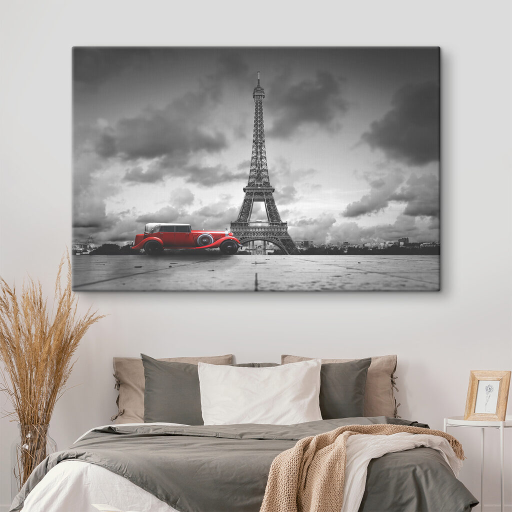 A red car parked in front of a large tower A red car parked in front of a large tower