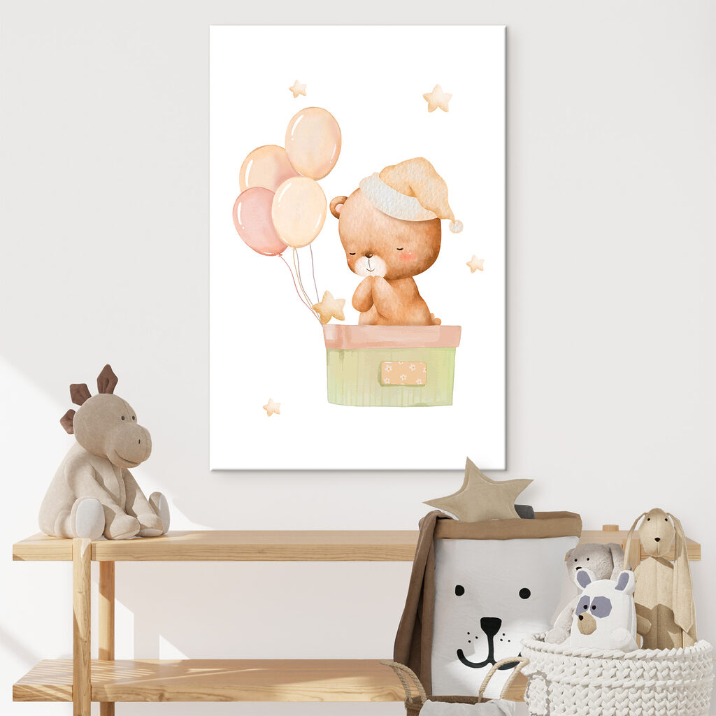 A teddy bear in a box with balloons
