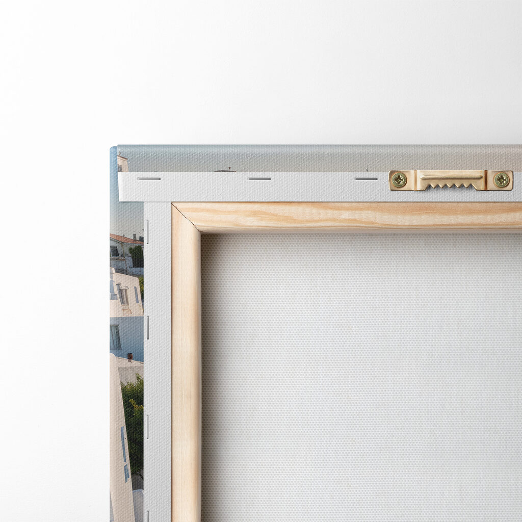 White buildings with blue domes on a hill with a body of water in the background