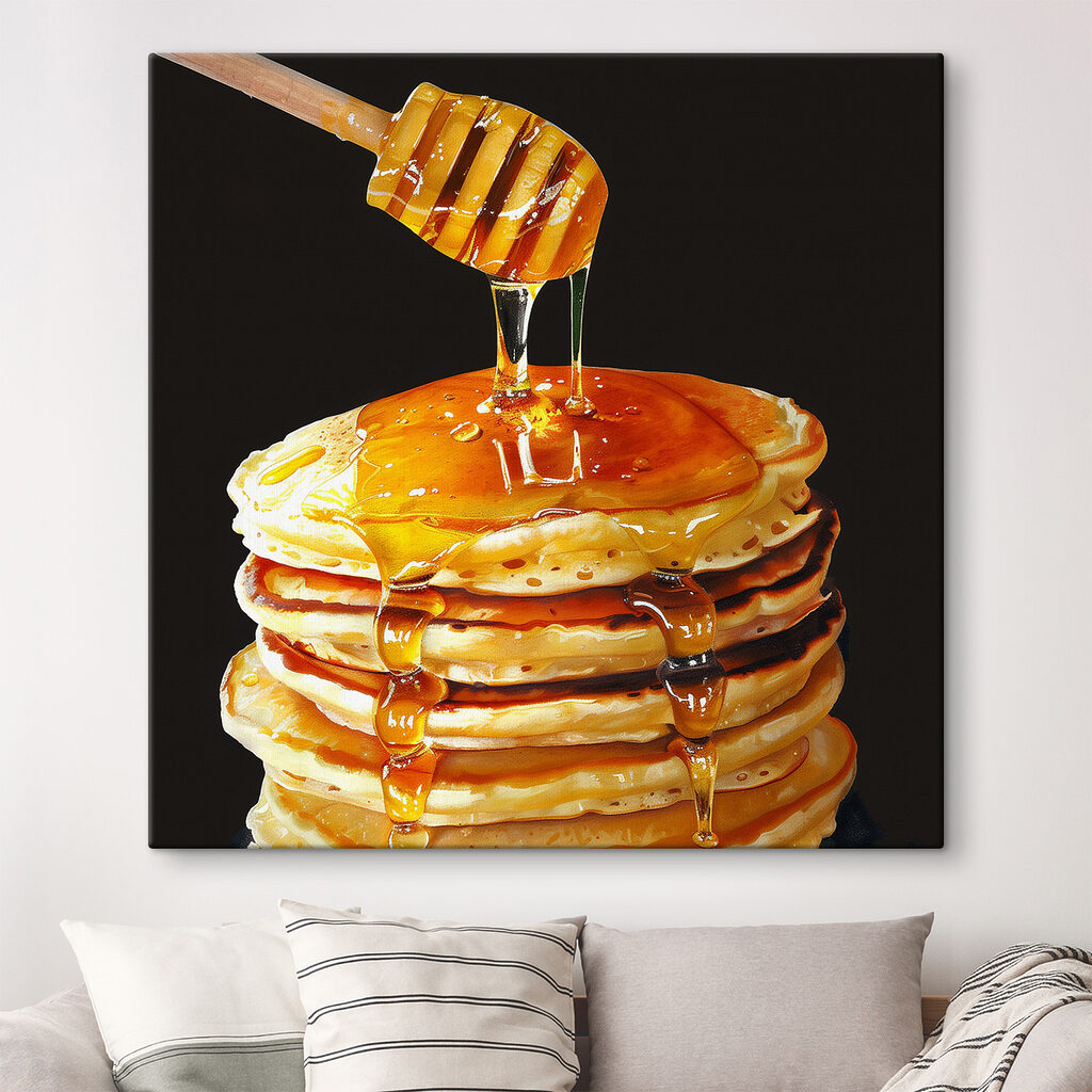 Stack of pancakes with honey dripping from a wooden stick