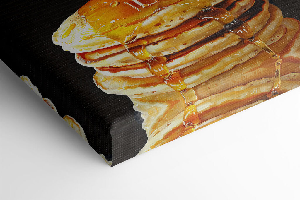 Stack of pancakes with honey dripping from a wooden stick