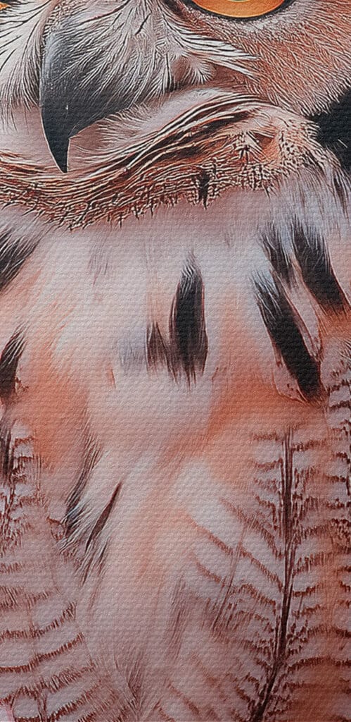 An owl in a tree with pink flowers An owl in a tree with pink flowers