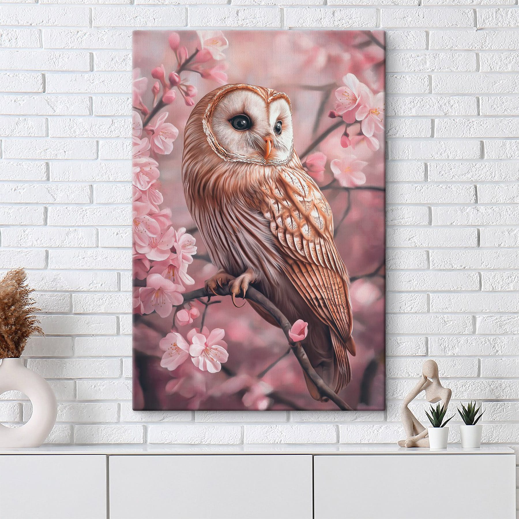 Owl sitting on a branch with pink flowers Owl sitting on a branch with pink flowers