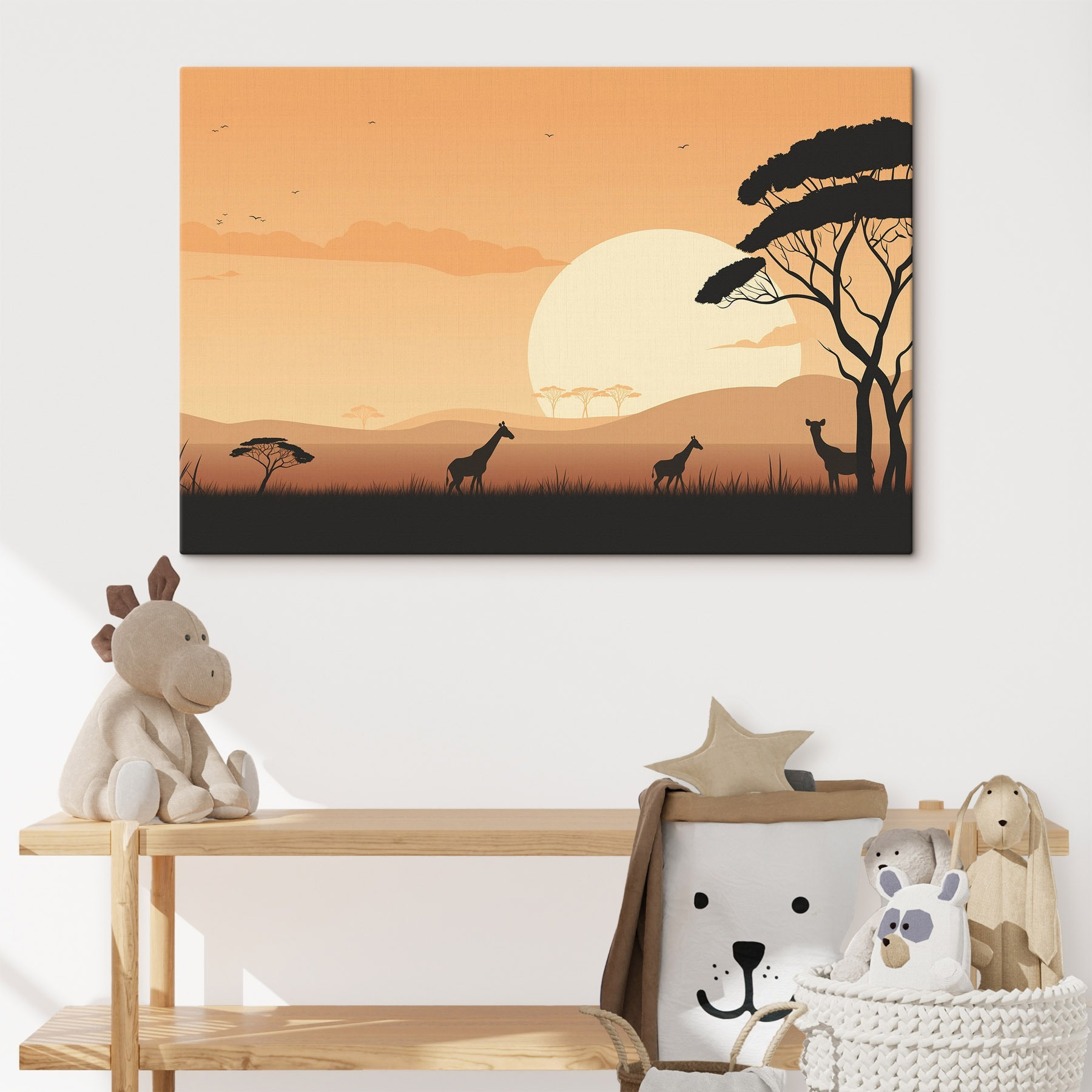 Giraffes walking in a grassy field with trees and a sunset