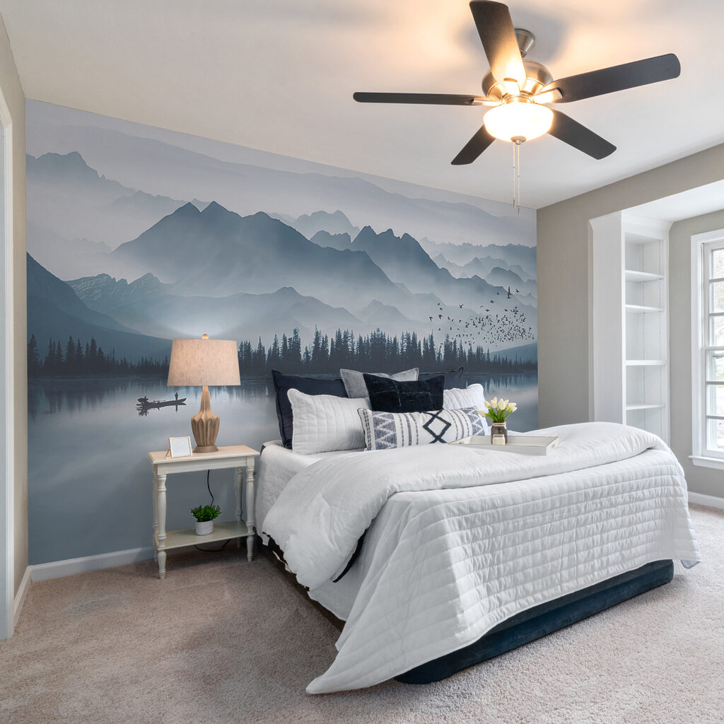 Person in a boat on a lake with mountains in the background