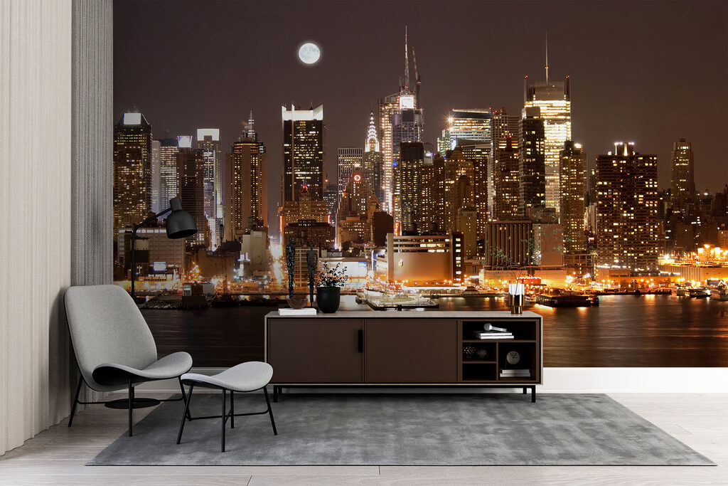 City skyline at night with the moon in the sky