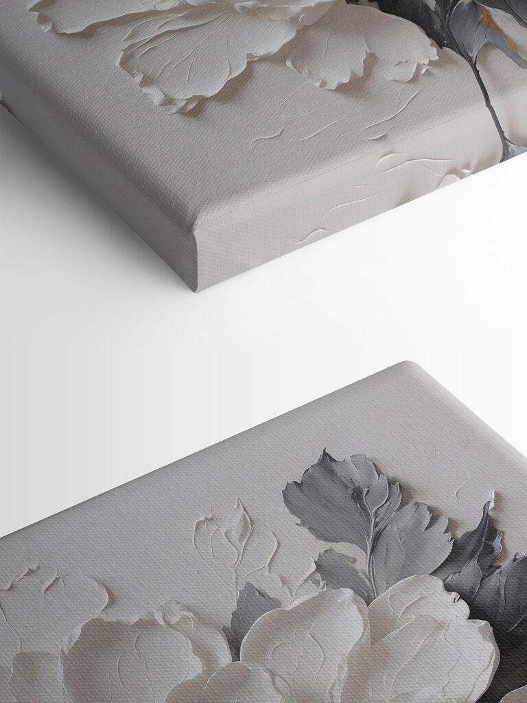 A white flower with black and grey leaves