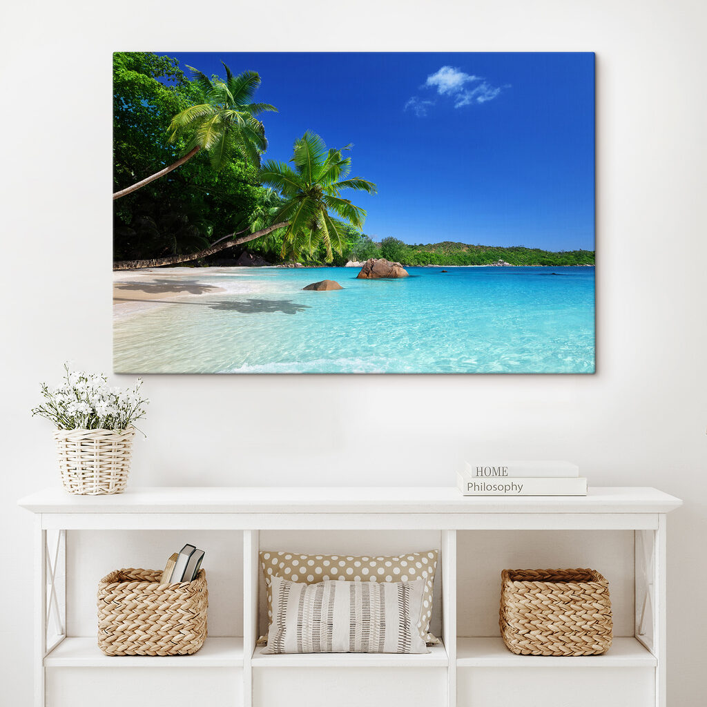 A beach with palm trees and blue water