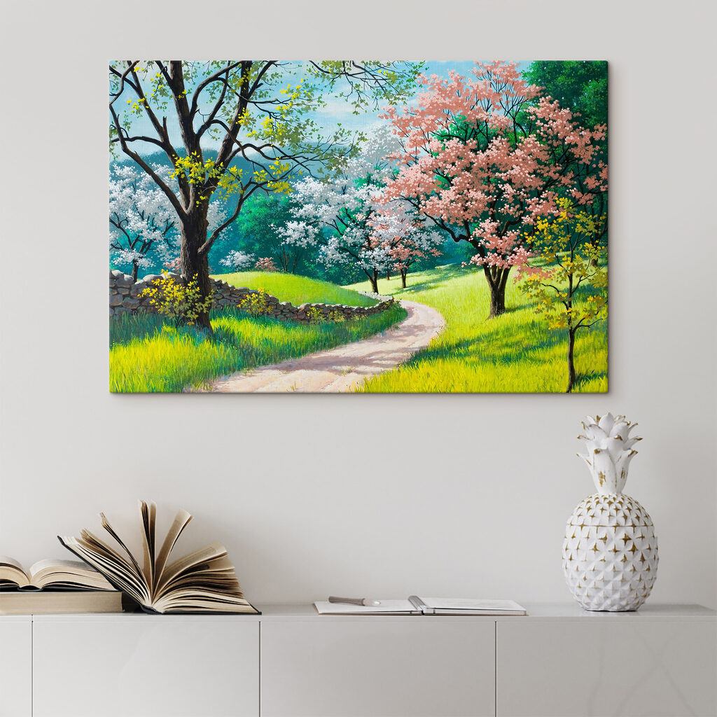 A dirt road through a grassy field with trees and a stone wall A dirt road through a grassy field with trees and a stone wall