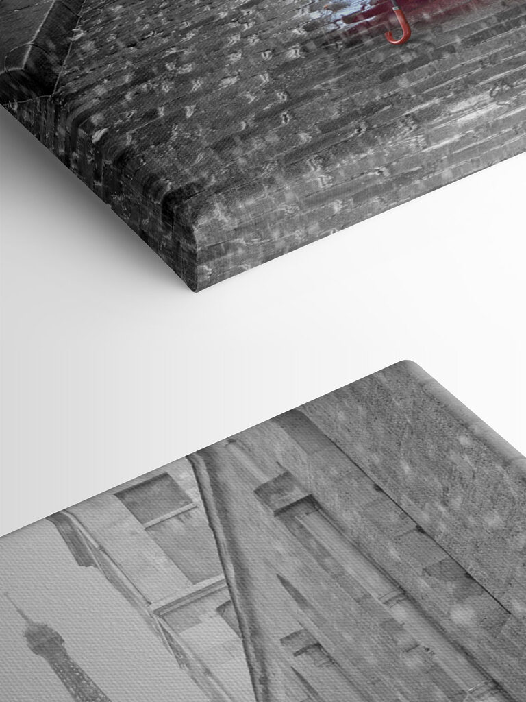 A red umbrella in a street with a tower in the background