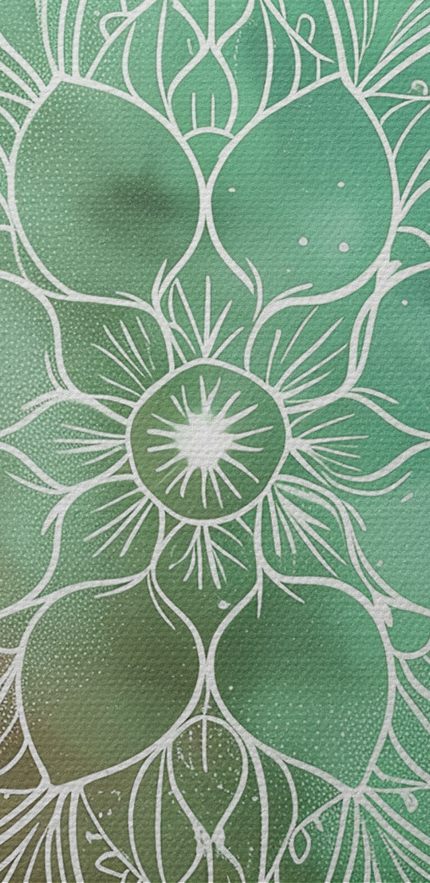 A white mandala on a green and blue background A white mandala on a green and blue background