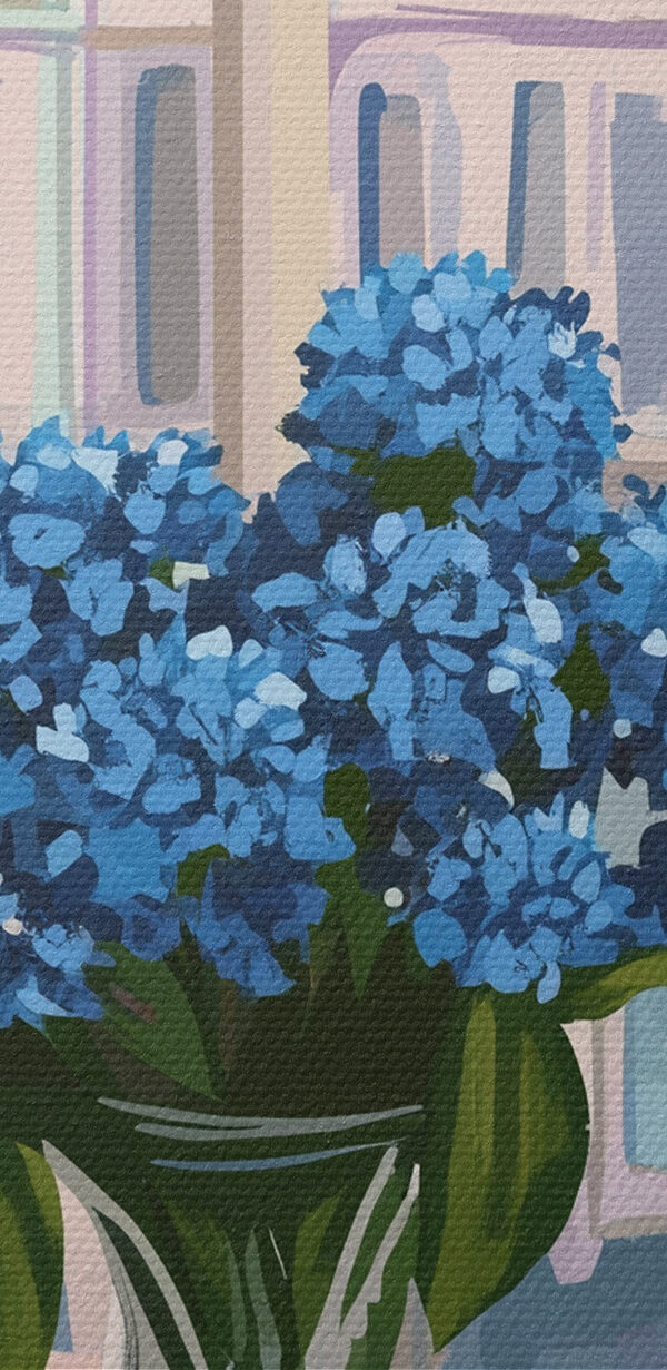 Vase of flowers and a candle in front of a window