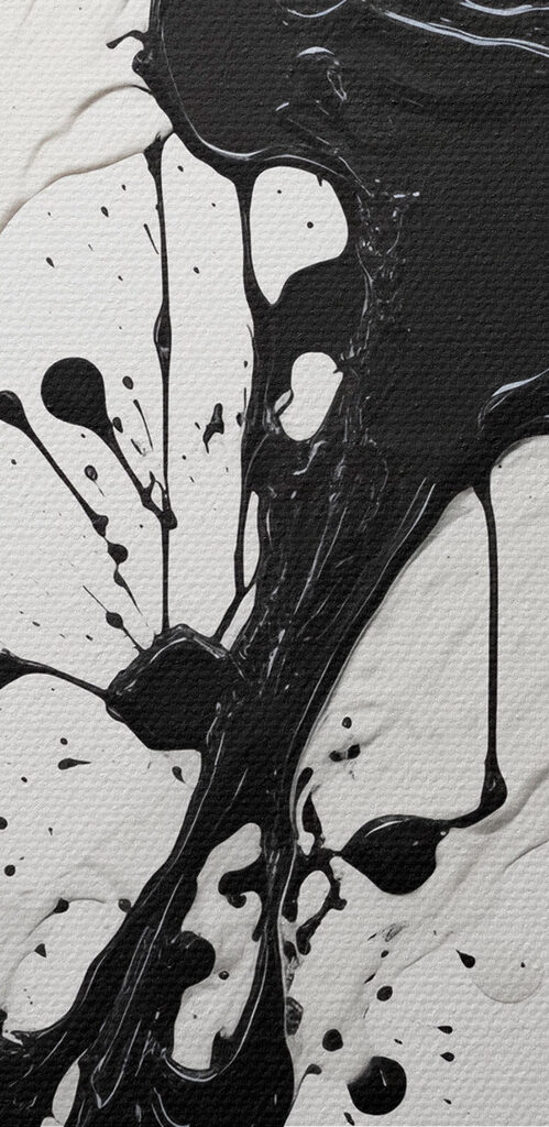 Black and white paint splattered on a white surface Black and white paint splattered on a white surface