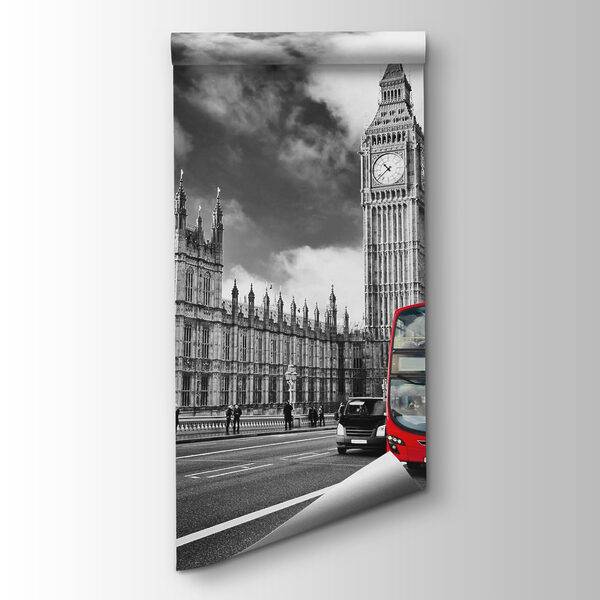 Red double decker bus on a street with a clock tower in the background