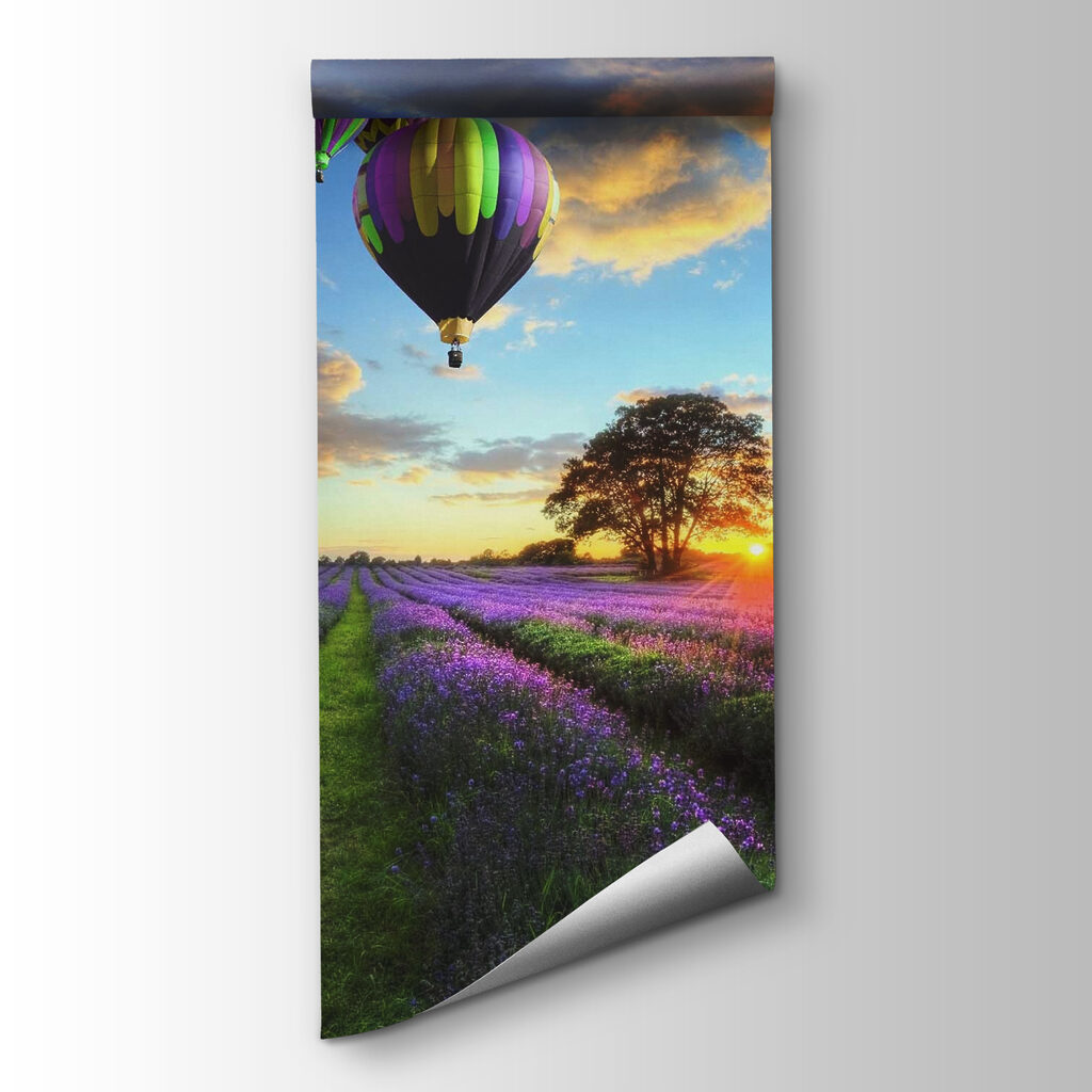 Group of hot air balloons flying over a field of flowers