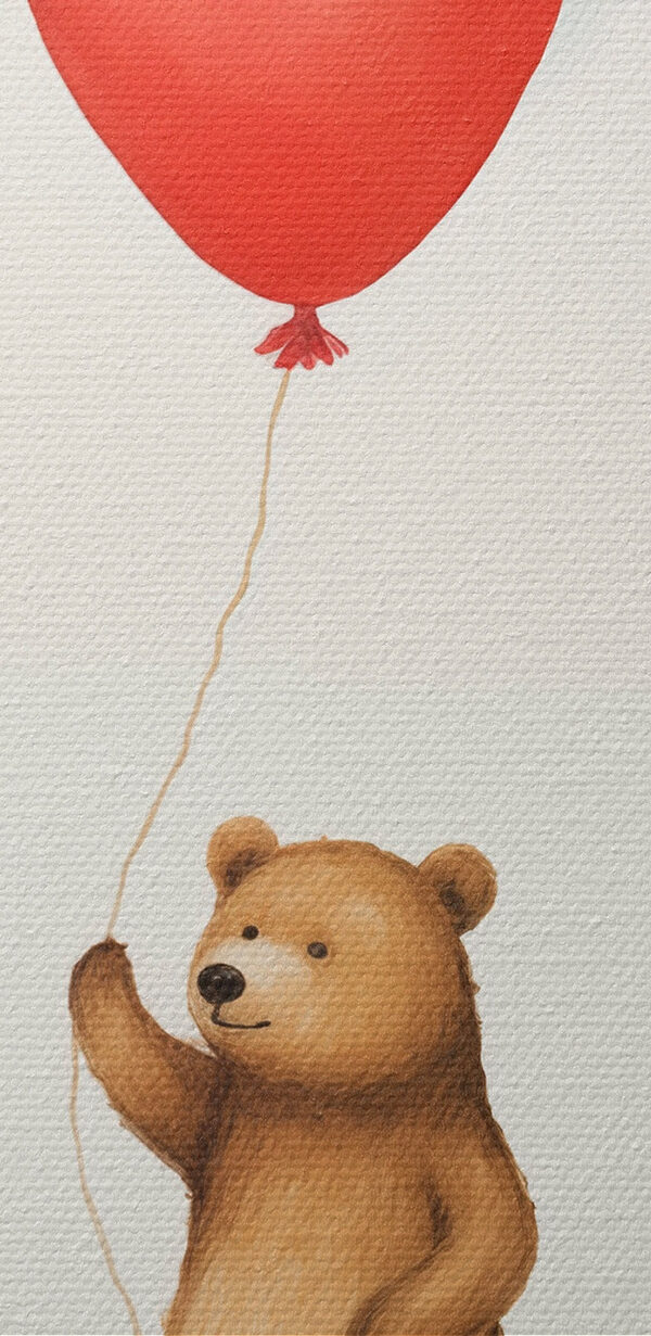 Bear holding a red balloon